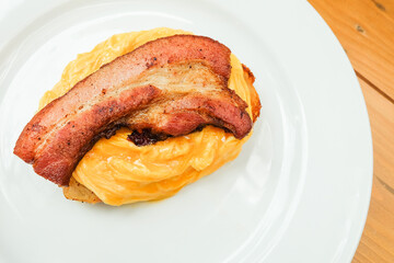 Scrambled eggs and Big Bacon with Sourdough and maple sauces,Breakfast view a bunch of Bacon omelette Toasts in cozy restaurant.