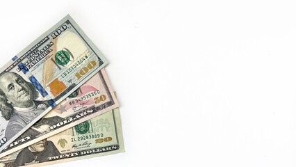 Close-up of US dollar bills including 20, 50, and 100 denominations, arranged neatly on a clean white background with ample copy space. Ideal for financial themes, investment ads, or banking promotion