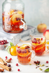 Homemade hot alcohol cranberry orange apple cider punch with cinnamon sticks, anise star and spices. Thanksgiving drink