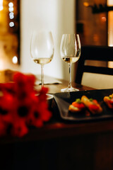 Two glasses of white wine stand on the table, restaurant, date, meeting, Valentine's Day, love, feeling
