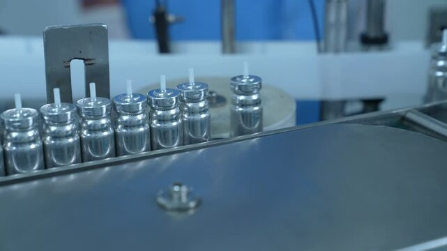 inhaler canister manufacturing, asthma puff in production line. inhaler manufacturing. canister making process in a factory. asthma medicine in metal bottles on a conveyor belt. Pharmaceutical product