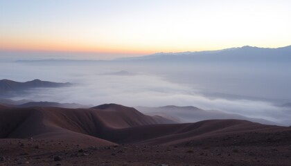 Fototapeta premium Sunrise over misty mountain range, view from high peak.