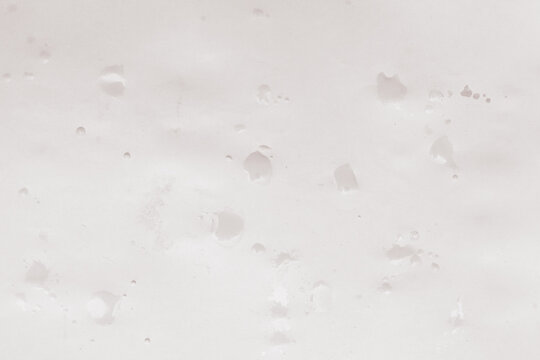 Drops of monochrome paint on a white sheet of paper, artist's studio. Creative background for your design or addition to illustrations.