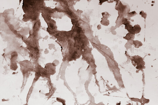Unusual patterns of watercolor monochrome paints, on a wet sheet of paper, in the artist's studio. Beautiful background for your creative design or illustrations.