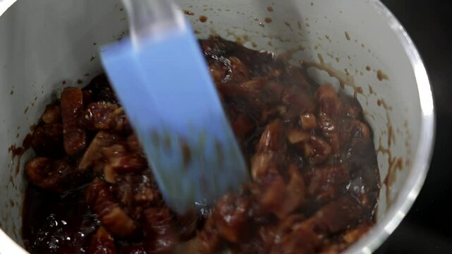 the pastry chef cooks the fruit in a pan to make jam for the cake
