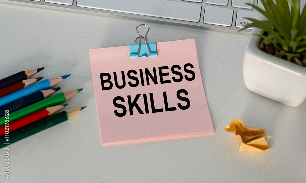 Poster business skills text on a notebook with chart on wooden background.