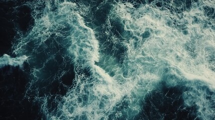 Fototapeta premium Vibrant ocean waves crashing against each other during the day’s light in a coastal area