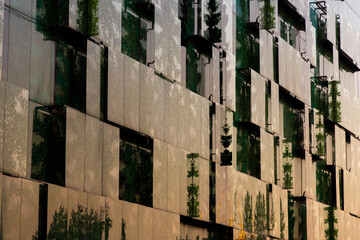 A modern building in Moscow with a unique facade composed of many rectangular windows reflecting...