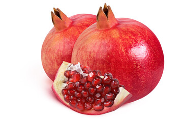 Pomegranates on an isolated white background. Two whole and one slice with seeds.