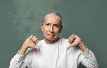  looking sad, disappointed or angry, showing thumbs down in disagreement, feeling frustrated