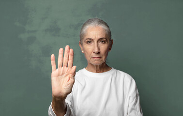  looking serious, stern, displeased and angry showing open palm making stop gesture