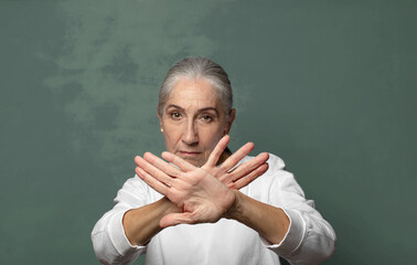  covering face with hand and putting other hand up front to stop camera, refusing photos or pictures