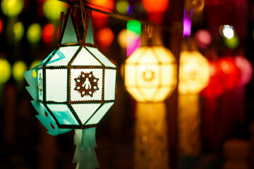 Close up of colourful light from Sa paper hang lanterns in the night with seamless blur background, Northern Thai Style Lanterns at Loi Krathong (Yi Peng) Festival, Chiang Mai, Thailand.