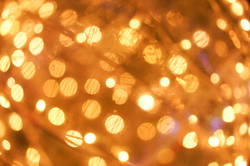 Abstract blur golden bokeh of bamboo light lamp. Horizontal seamless background or banner with blurred circular glow bokeh effects for christmas time. Happy New Year or Special occasion concept.