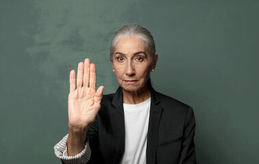  looking serious, stern, displeased and angry showing open palm making stop gesture