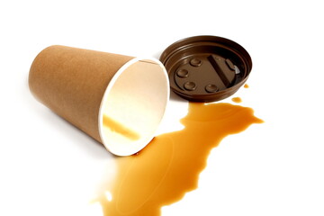 Spilled coffee residue with paper cup lies on white background.	