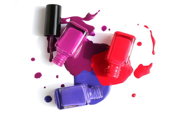 Open spill varnish of three colors in glass bottles is located on a white background.