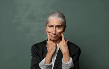  smiling confidently pointing to own fake smile