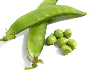 Green fresh peas lie on a white background.	
