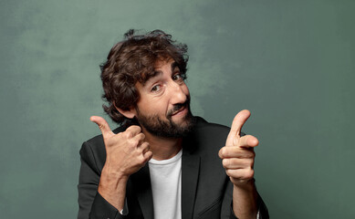  smiling cheerfully and pointing to camera while making a call you later gesture, talking on phone