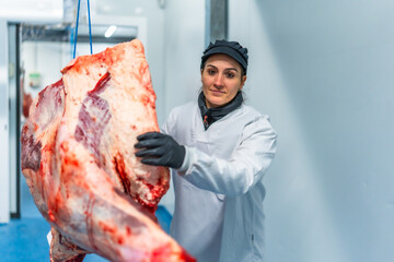Butcher working at the slaughter house sorting meat