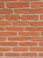 Obraz premium Close-up photo of weathered red brick wall with rough and uneven texture, textured, background