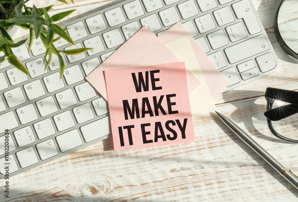Poster we make it easy text in the notebook on a blue table. top view - business concept.