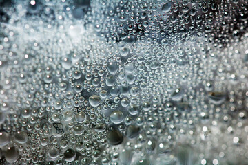 CLose Up of Condensation Bubbles and Marks on A Window Water Background