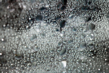 CLose Up of Condensation Bubbles and Marks on A Window Water Background