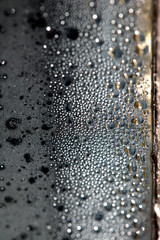 CLose Up of Condensation Bubbles and Marks on A Window Water Background