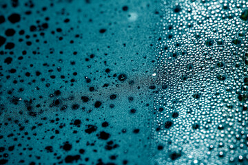 CLose Up of Condensation Bubbles and Marks on A Window Water Background