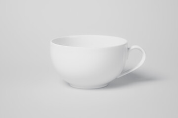 A white cup sits on a white background. The cup is empty and has a handle. Concept of simplicity and minimalism