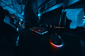 Gaming setup with illuminated keyboard and mouse in a dark environment