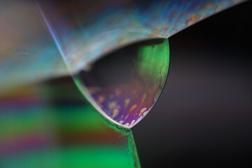 Bright rainbow reflection of liquid in macro, white colors, surrealistic background, fantastic...