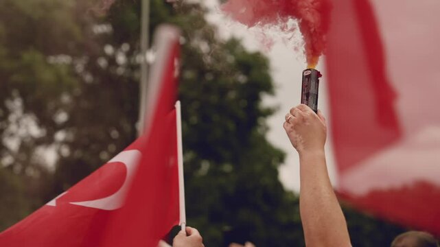 Colorful smoke bombs in action with Turkish fans waving flags, representing sports celebrations, social movements, protests, and dramatic visuals, emphasizing fandom and cultural pride