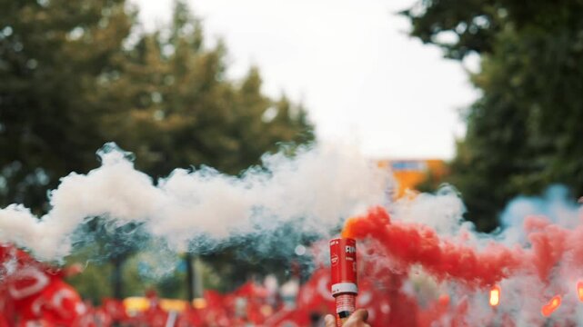 Colorful smoke bombs in action with Turkish fans waving flags, representing sports celebrations, social movements, protests, and dramatic visuals, emphasizing fandom and cultural pride