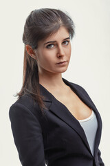 Fototapeta premium Serious young businesswoman looking at the camera