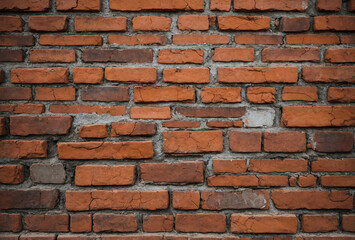 Fototapeta premium rustic brick wall with visible cracks and imperfections