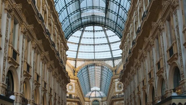 Interior of Galleria Vittorio Emanuele II in Milan, Italy. Oldest Italian shopping mall neoclassical architecture with grand glass dome and decorative details in Milano city