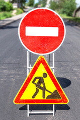 Road works sign at the city street. Carrying out construction and repair work in the city