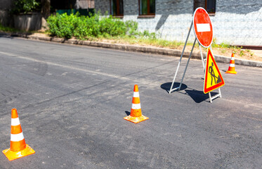 Road works sign at the city street. Carrying out construction and repair work in the city