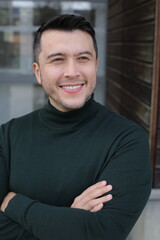 Handsome Hispanic entrepreneur wearing a classy turtle neck sweater 