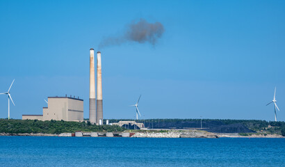 Clean and not so clean energy -A coal-fired power plant surrounded by windmill power generators