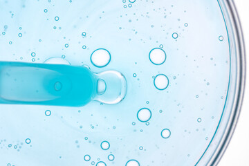 Blue Liquid with Bubbles in Petri Dish Captures Microscopic View