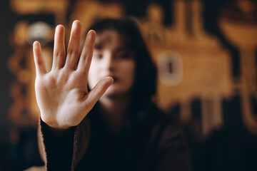 Woman Expressing Stop Gesture with Open Hand Focused in Foreground