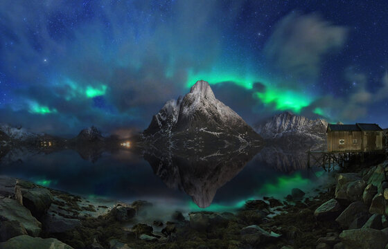 Majestic northern lights over snowy mountains and calm lake - Powered by Adobe
