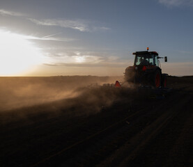 Fototapeta premium Tractor preparing the land for a new crop planting