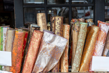 Japanese textiles collection at a shop display, Rolls of fabric brocade and silk, used for traditional kimono