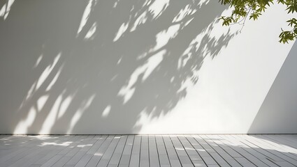 Fototapeta premium Minimalist Photograph of White Wall with Soft Tree Shadows and Green Leaves