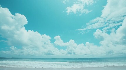 Obraz premium Turquoise ocean water gently washing the shore of a tropical beach with white sand and a cloudy sky forming a breathtaking view of paradise